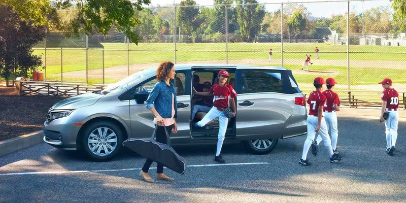 Family exiting 2024 Honda Odyssey to baseball game