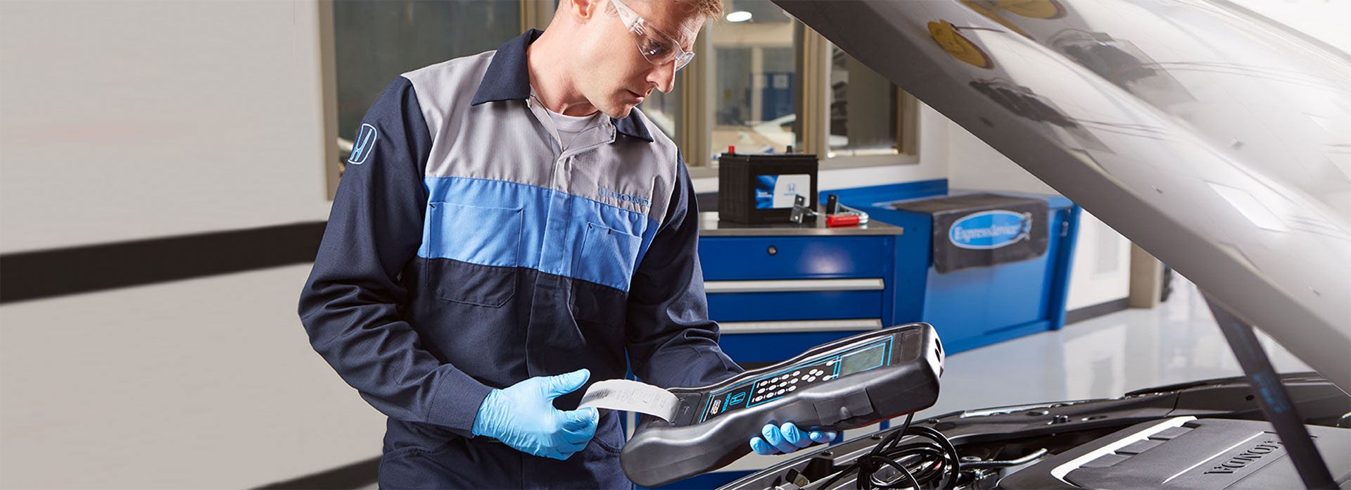 Honda Certified Service Technician performing check on Honda vehicle battery