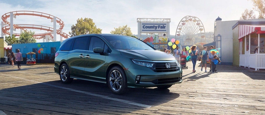 Frontal view of the 2021 Honda Odyssey parked in front of a county fair